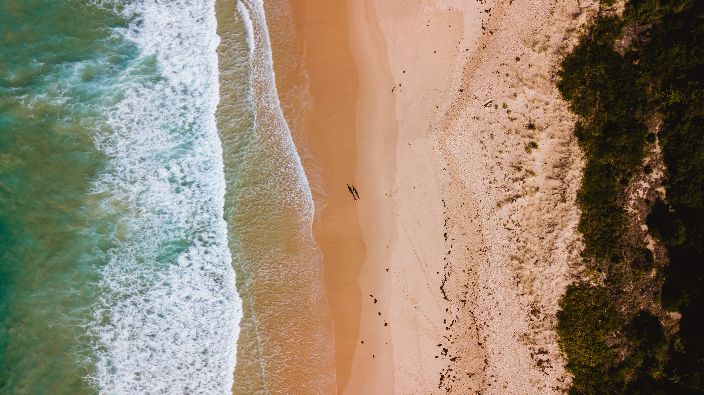 Waves rolling onto the sand at Mollymook Beach
